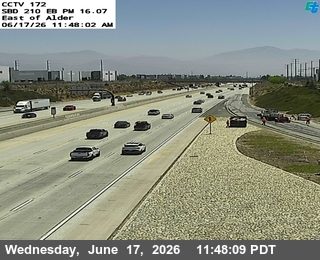 Emergency responders and vehicles are present on the right shoulder of the highway.