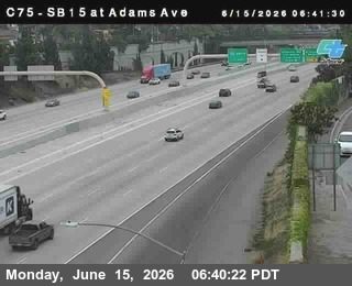 Police car and tow truck on the right shoulder, traffic moving