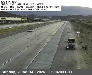 Emergency responders and vehicles on the shoulder of the highway.