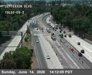 Emergency responders and vehicles are present on the highway, indicating an incident.