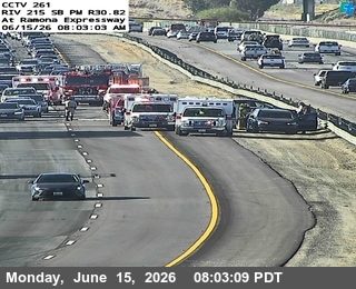 Emergency responders and vehicles on the side of the highway, indicating an incident.
