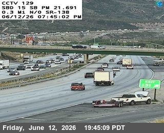 White truck with open hood and trailer stopped on shoulder, emergency lights visible.