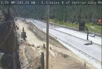Construction zone with emergency vehicle and personnel present on the roadway.