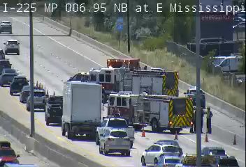 Multiple emergency vehicles and personnel on the highway, indicating an incident response.