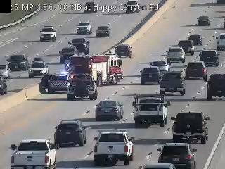 Fire engine and police car with lights on the shoulder