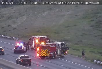 Fire truck and police car with lights on the right shoulder