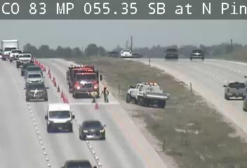 Fire truck and other emergency vehicles on the side of the highway.