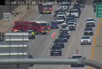 Fire truck with lights on in the left lane