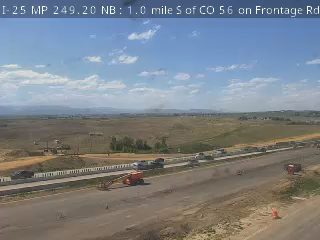 Construction vehicles and cones on the highway suggest ongoing work or an incident.