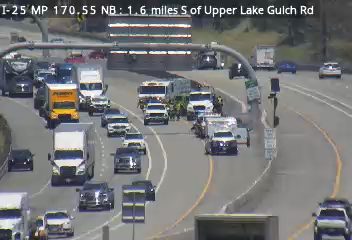 Multiple emergency vehicles and personnel in the median