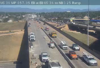 Emergency vehicles and cones on the highway, indicating an incident response.