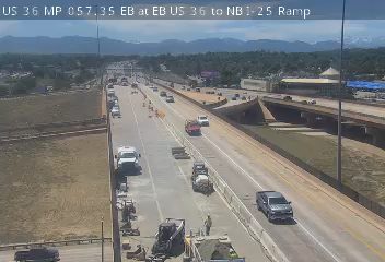 Construction vehicles and personnel on the roadway, possibly indicating a work zone incident.