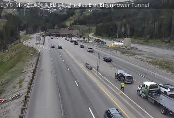 Vehicle stopped on shoulder with emergency responders present.
