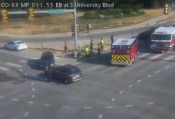 Ambulance and fire truck with emergency lights on at intersection
