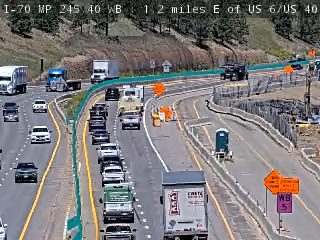 Construction zone with cones and a portable toilet, indicating ongoing work.