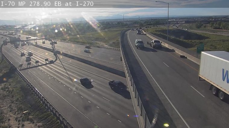 A tire is visible on the roadway, potentially a hazard.