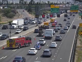 Fire engine and two other emergency vehicles with lights on in the left lanes