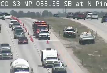 Fire truck and other vehicles responding to an incident on the highway.