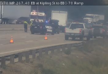 Police and emergency vehicles on scene of an incident on the highway.