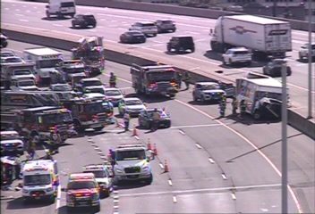 Multiple emergency vehicles and personnel on the roadway