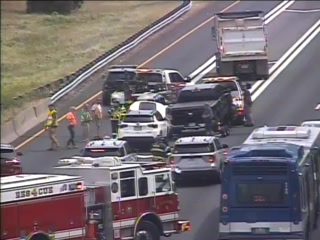 Fire truck and responders on scene of a multi-vehicle crash on the highway.