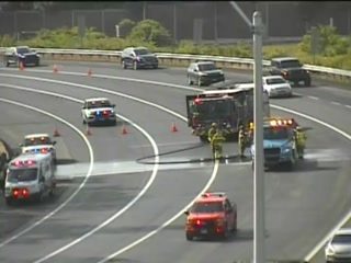 Emergency responders and vehicles are on scene of an incident on the highway.