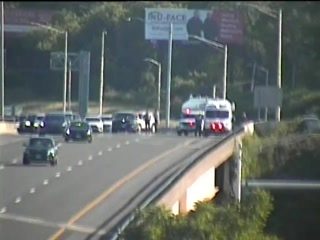 Emergency responders and vehicles on the side of the highway.
