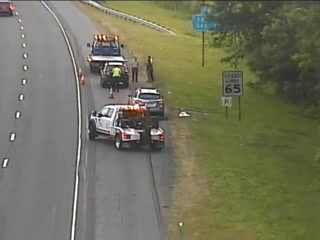 Multiple tow trucks and personnel on the roadside assisting a vehicle.