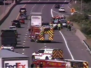 Fire truck and other emergency vehicles with lights on in the right lane