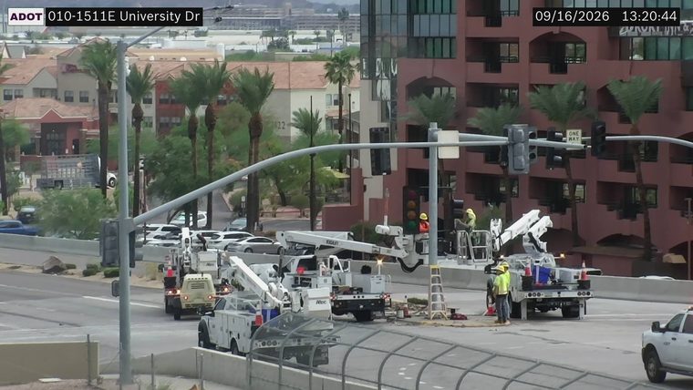 Workers and utility trucks in the roadway