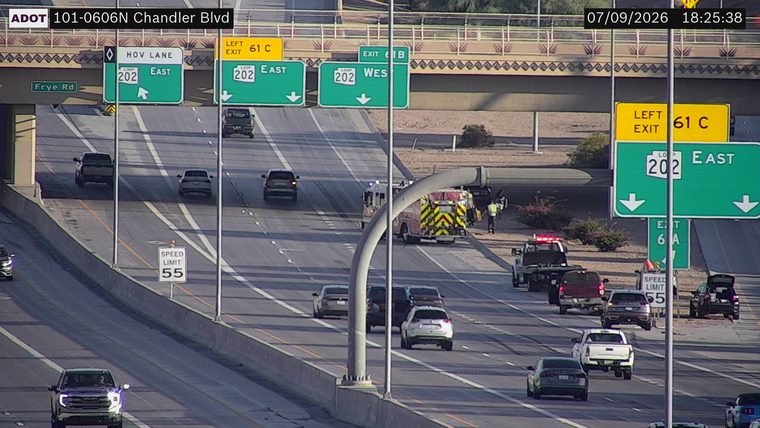 Fire truck and tow truck with emergency lights on the right shoulder