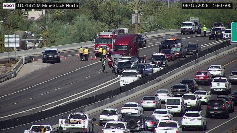 Multiple emergency vehicles and personnel attending to a multi-vehicle incident in the left lanes