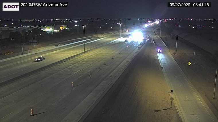 Construction cones and a vehicle with bright lights in the right lane