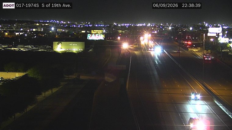 Multiple emergency vehicles with lights on in the right lanes