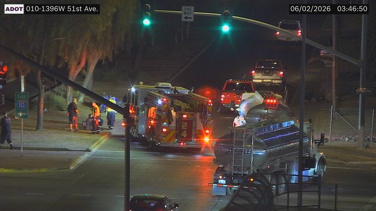 Fire truck and several people on the side of the road near the intersection