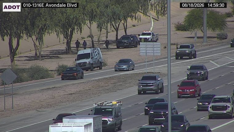 Police SUV and a white truck with emergency lights on the shoulder