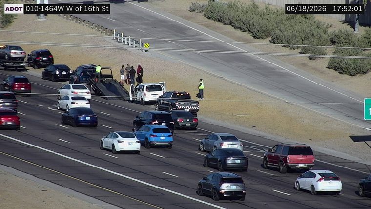 Tow truck assisting a white SUV with doors open on the right shoulder