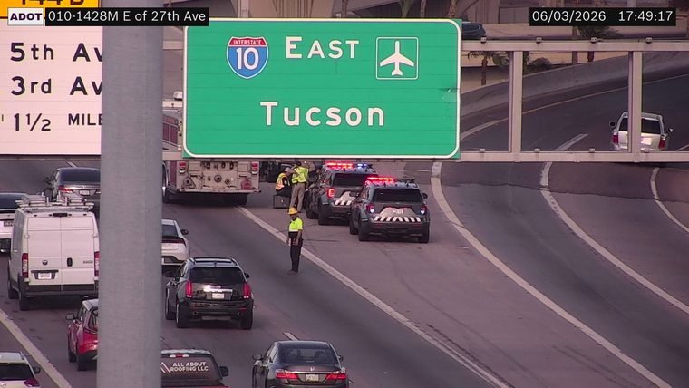 Multiple police vehicles and a fire truck with emergency lights on in the right lane