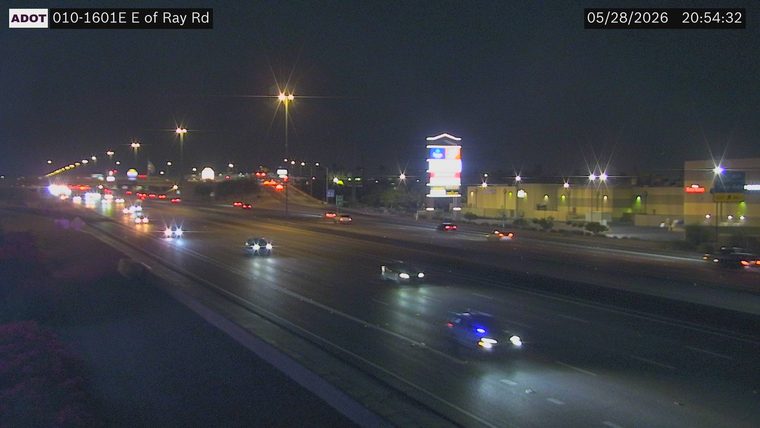 Police car with flashing blue lights in the right lane