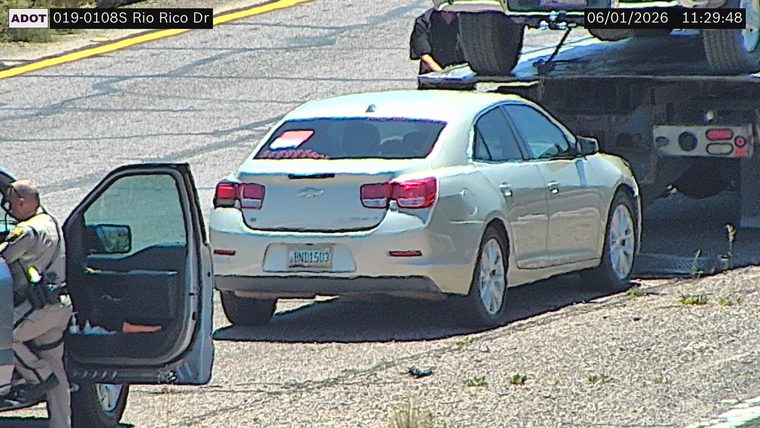 Trooper assisting a vehicle on the right shoulder