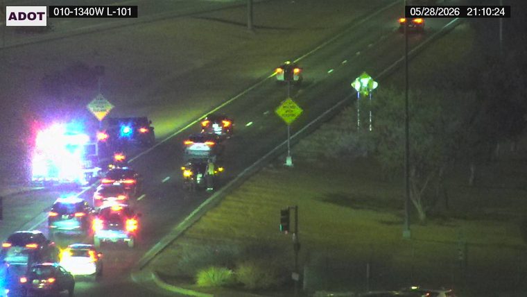 Emergency vehicle with flashing lights in the left lane