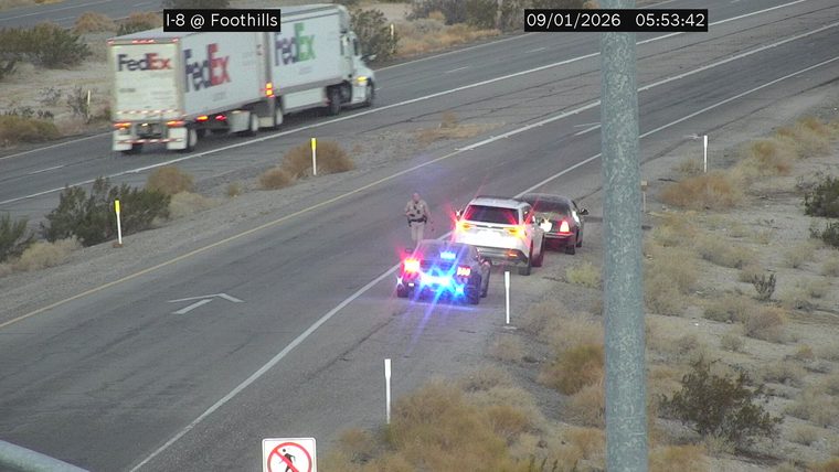 Police car with red and blue lights on the shoulder