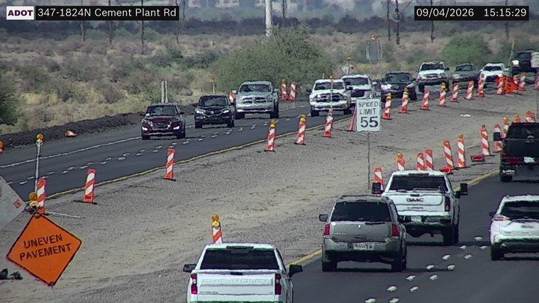 Uneven pavement sign and construction cones in the roadway