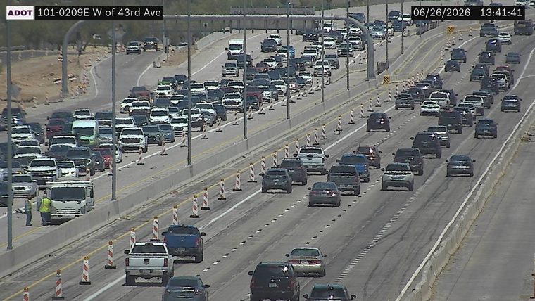 Construction cones and workers in the left lanes
