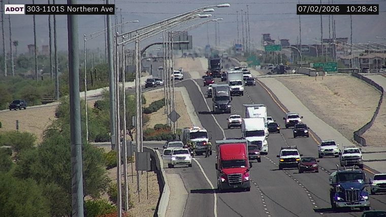 Fire truck with lights on in the left lane