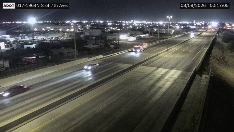 Fire truck with flashing lights in the right lane