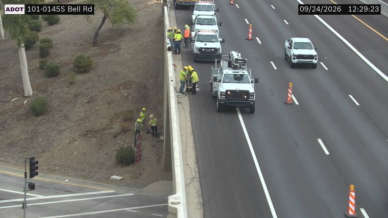 Workers and equipment on the right shoulder and in the right lane