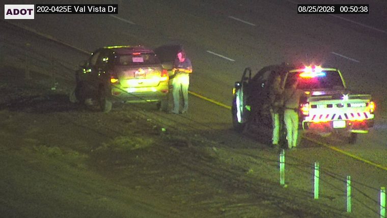 Marked police vehicle with red and blue lights on the shoulder