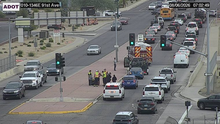 Group of people and a fire truck on the sidewalk