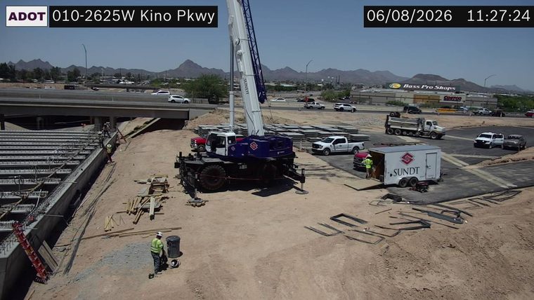 Construction workers and equipment on roadway